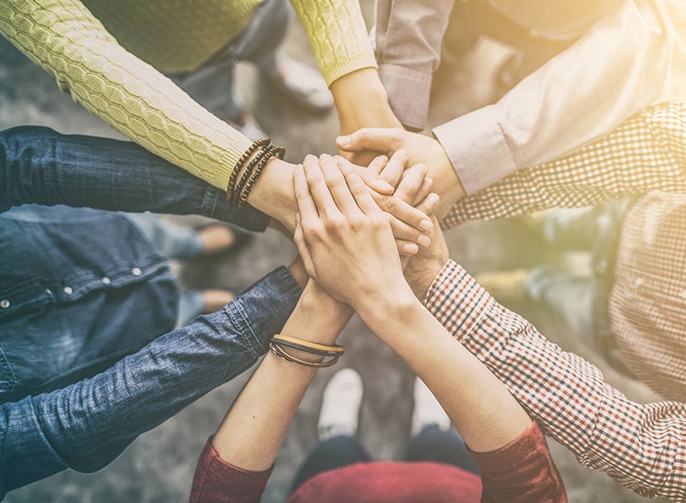 huddle with hands together