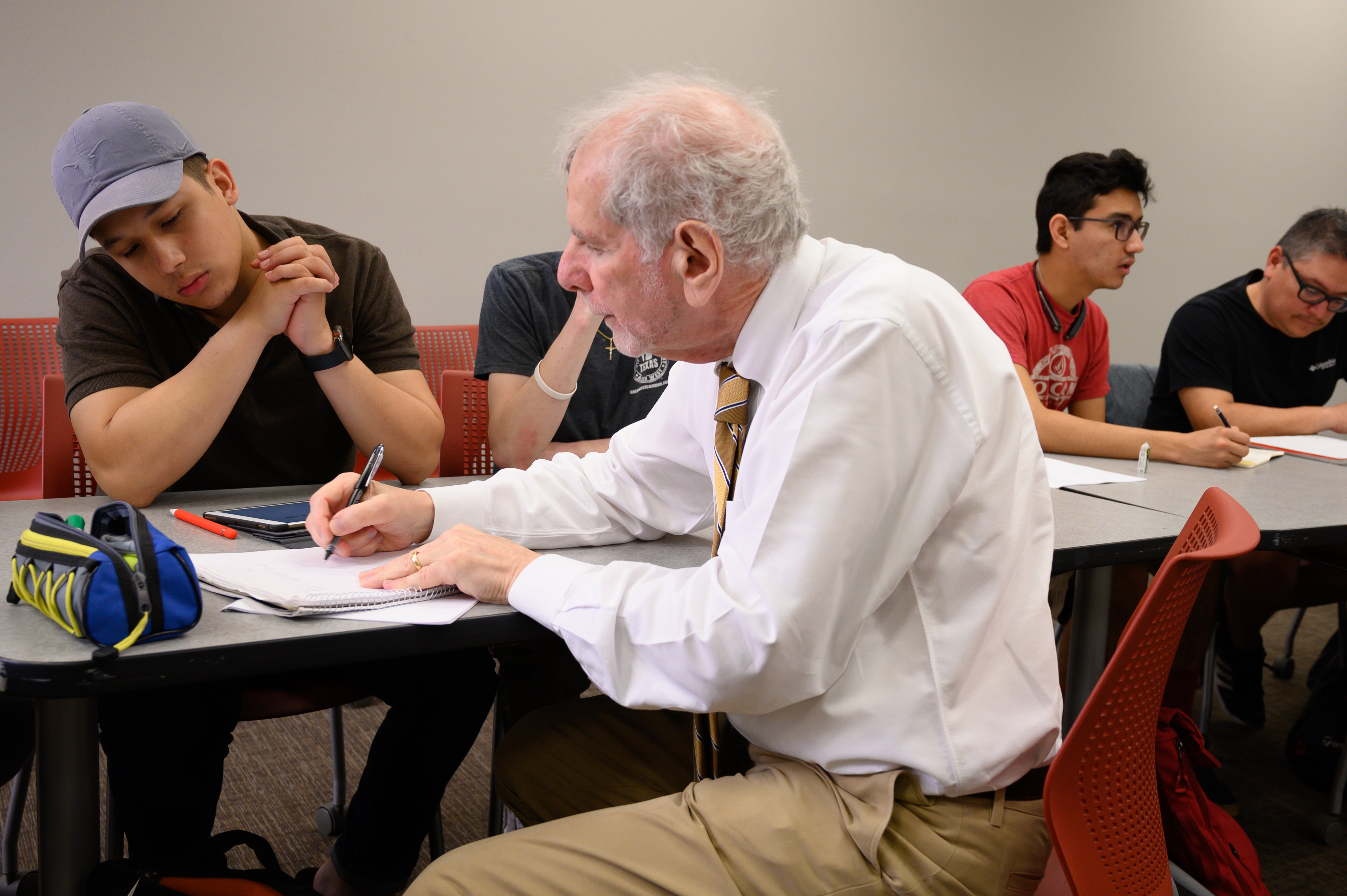 Uri teaching at desk