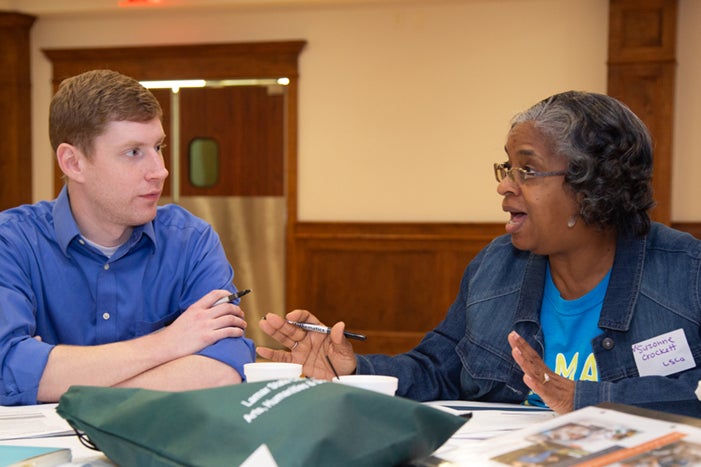 two people at a table having a discussion about co-requisite implementation