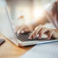 close up of hands on a laptop