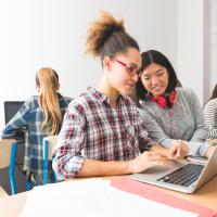 Two high school girls working on a laptop