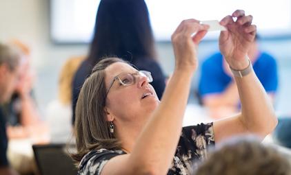 woman looking at a paper in the air