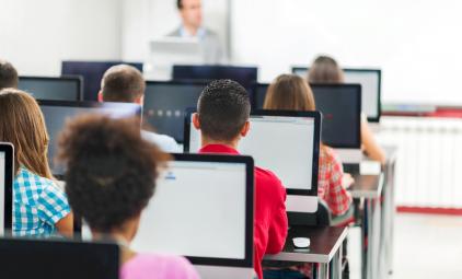 students with computers in a classroom