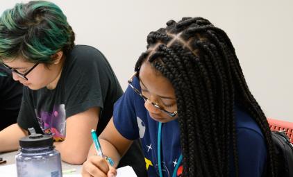 Three female students work on an assignment in Uri Treisman's freshman Calculus class (2019).