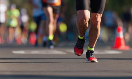 photo of a person's legs running a marathon