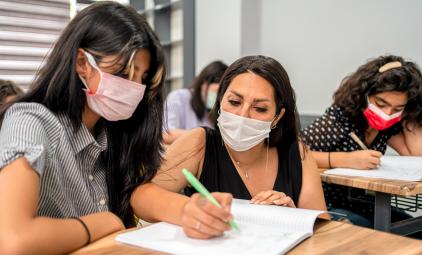 teacher helping a student