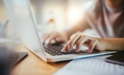 close up of hands on a laptop