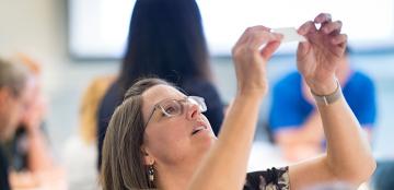 woman looking at a paper in the air