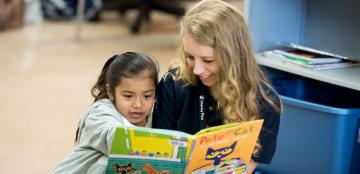 Reading tutor working with student.