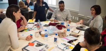 Group of adults working around a table.