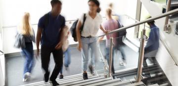 Blurry students walking up stairs.