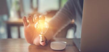 Woman holding a lightbulb.