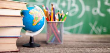 desk with books, globe, and pencils