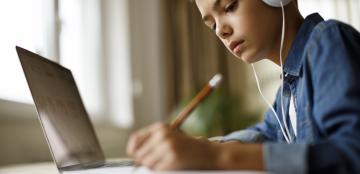 boy with headphones at a computer