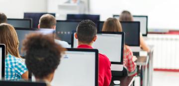 students with computers in a classroom