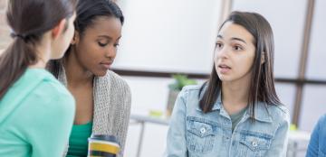 three students discussing a problem