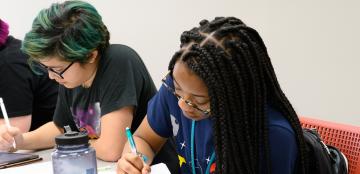 Three female students work on an assignment in Uri Treisman's freshman Calculus class (2019).