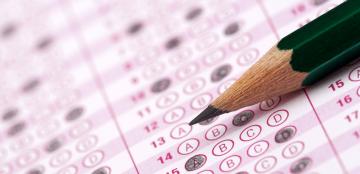 A standardized test paper with a pencil in closeup. 