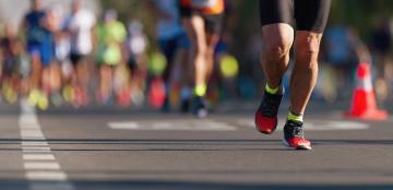 photo of a person's legs running a marathon
