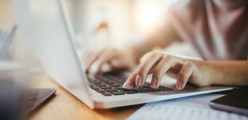 close up of hands on a laptop