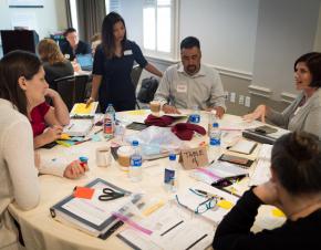 Group of adults working around a table.