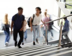 Blurry students walking up stairs.