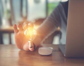 Woman holding a lightbulb.