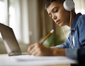 boy with headphones at a computer