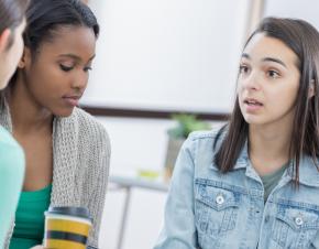 three students discussing a problem