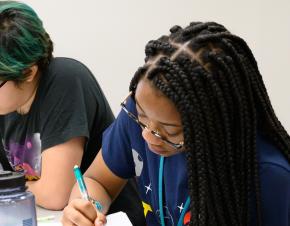 Three female students work on an assignment in Uri Treisman's freshman Calculus class (2019).