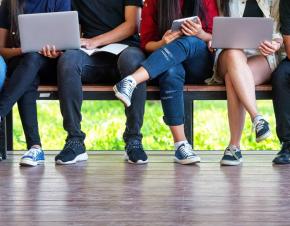 group of students sitting at a bench