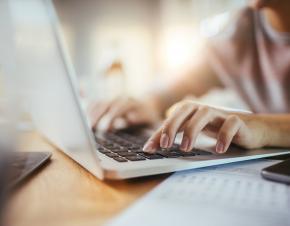 close up of hands on a laptop