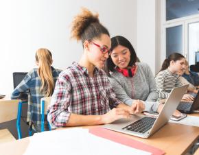 Two high school girls working on a laptop