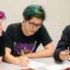 Three female students from Uri Treisman's freshman calculus class sit at a table discussing their work. 
