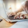 close up of hands on a laptop