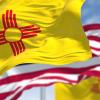 New Mexico and American flags in a breeze